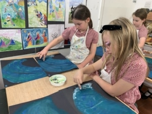 Heritage Year 4 pupils paint water and waves.