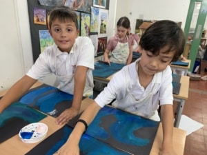 Heritage Year 4 pupils paint water and waves.
