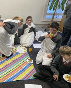 Year 5 pupils enjoy a Roman Saturnalia banquet during their Latin lessons