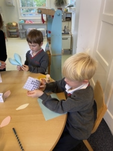 Upper Prep pupils making colourful kites in the classroom.