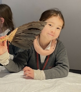 Upper Prep pupils examining artefacts and engaging in enquiry-based learning during a visit to the Museum of Archaeology and Anthropology.