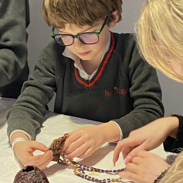 Upper Prep pupils examining artefacts and engaging in enquiry-based learning during a visit to the Museum of Archaeology and Anthropology.