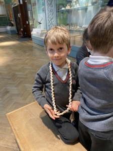 Upper Prep pupils examining artefacts and engaging in enquiry-based learning during a visit to the Museum of Archaeology and Anthropology.