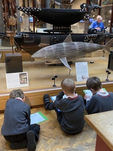 Upper Prep pupils examining artefacts and engaging in enquiry-based learning during a visit to the Museum of Archaeology and Anthropology.