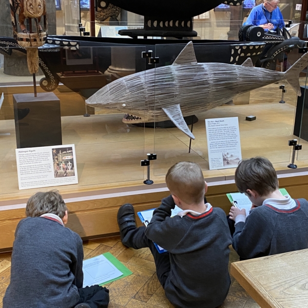Upper Prep pupils examining artefacts and engaging in enquiry-based learning during a visit to the Museum of Archaeology and Anthropology.