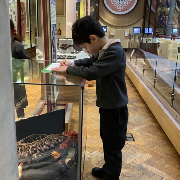 Upper Prep pupils examining artefacts and engaging in enquiry-based learning during a visit to the Museum of Archaeology and Anthropology.