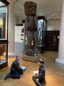 Upper Prep pupils examining artefacts and engaging in enquiry-based learning during a visit to the Museum of Archaeology and Anthropology.
