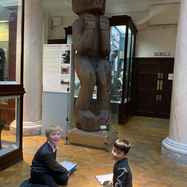 Upper Prep pupils examining artefacts and engaging in enquiry-based learning during a visit to the Museum of Archaeology and Anthropology.