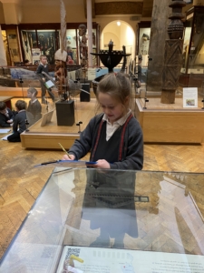 Upper Prep pupils examining artefacts and engaging in enquiry-based learning during a visit to the Museum of Archaeology and Anthropology.
