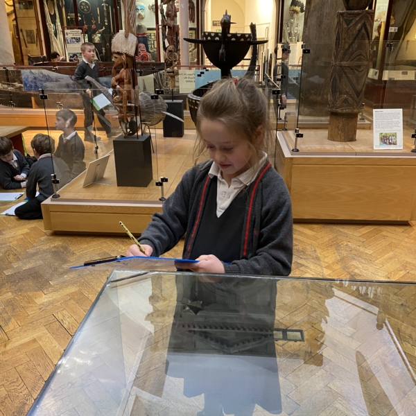 Upper Prep pupils examining artefacts and engaging in enquiry-based learning during a visit to the Museum of Archaeology and Anthropology.