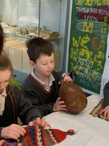 Upper Prep pupils examining artefacts and engaging in enquiry-based learning during a visit to the Museum of Archaeology and Anthropology.