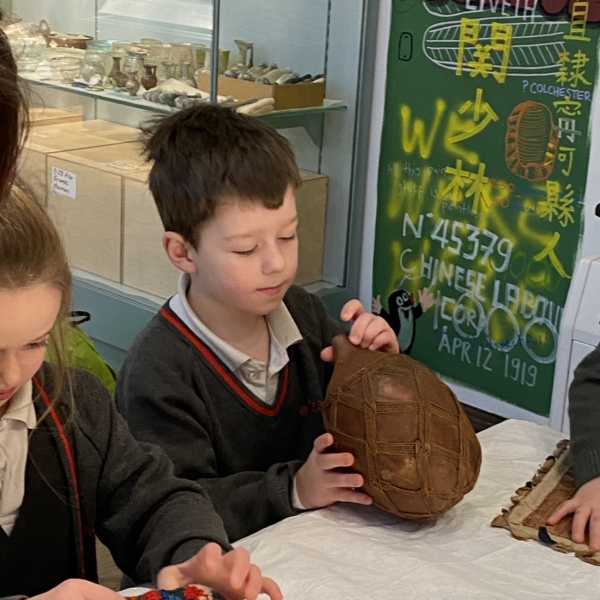 Upper Prep pupils examining artefacts and engaging in enquiry-based learning during a visit to the Museum of Archaeology and Anthropology.
