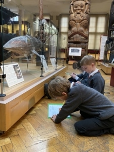 Upper Prep pupils examining artefacts and engaging in enquiry-based learning during a visit to the Museum of Archaeology and Anthropology.