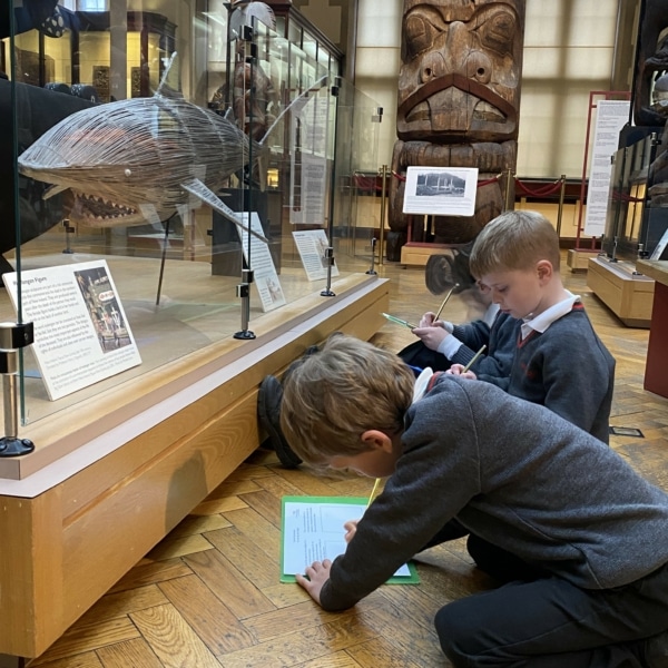 Upper Prep pupils examining artefacts and engaging in enquiry-based learning during a visit to the Museum of Archaeology and Anthropology.