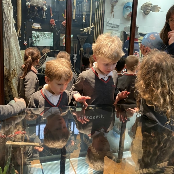 Upper Prep pupils examining artefacts and engaging in enquiry-based learning during a visit to the Museum of Archaeology and Anthropology.