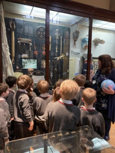 Upper Prep pupils examining artefacts and engaging in enquiry-based learning during a visit to the Museum of Archaeology and Anthropology.