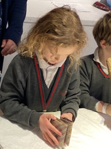 Upper Prep pupils examining artefacts and engaging in enquiry-based learning during a visit to the Museum of Archaeology and Anthropology.
