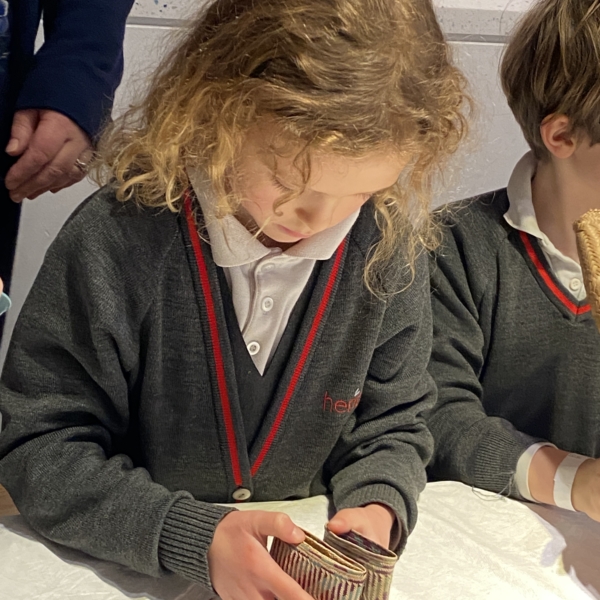 Upper Prep pupils examining artefacts and engaging in enquiry-based learning during a visit to the Museum of Archaeology and Anthropology.
