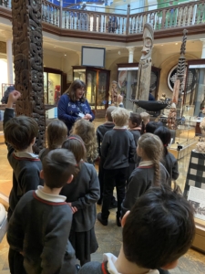 Upper Prep pupils examining artefacts and engaging in enquiry-based learning during a visit to the Museum of Archaeology and Anthropology.