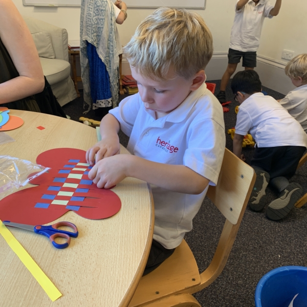 Heritage Upper Prep pupils do a paper weaving craft.