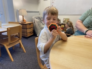 Upper Prep pupils weaving colourful yarn around conkers to create decorative patterns that build fine motor skills and coordination.