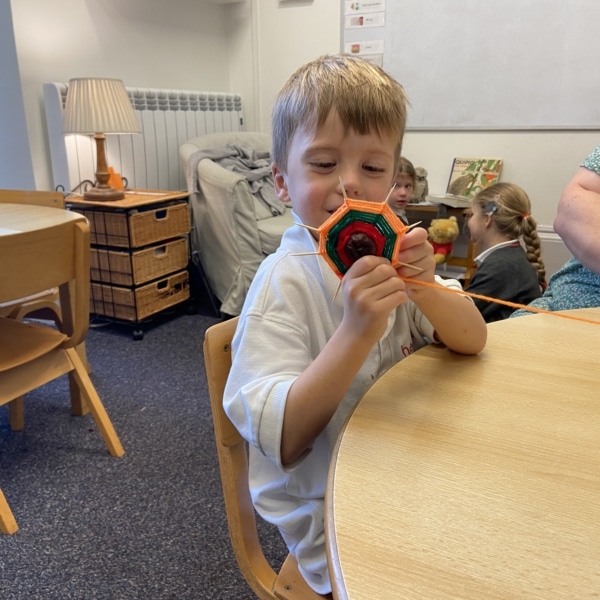 Upper Prep pupils weaving colourful yarn around conkers to create decorative patterns that build fine motor skills and coordination.
