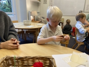 Upper Prep pupils weaving colourful yarn around conkers to create decorative patterns that build fine motor skills and coordination.
