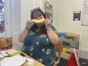 Year 2 pupils cutting pieces of colourful fruit for a fruit salad.