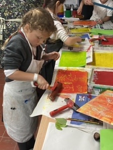 Year 2 pupils work with paint in this enrichment session