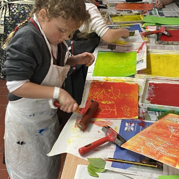 Year 2 pupils work with paint in this enrichment session