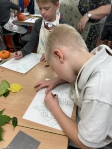 Year 2 pupils work with paint in this enrichment session