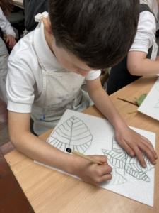 Year 2 pupils work with paint in this enrichment session