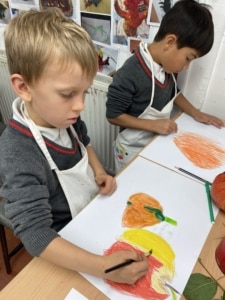 Year 2 pupils work with paint in this enrichment session