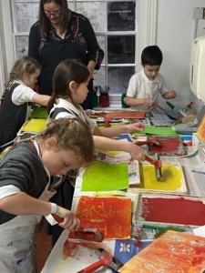 Year 2 pupils work with paint in this enrichment session