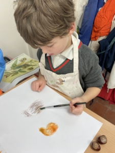 Year 2 pupils work with paint in this enrichment session