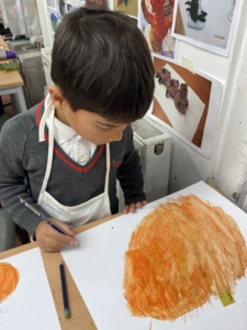 Year 2 pupils work with paint in this enrichment session