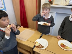 Heritage Year 2 pupils make pizzas during an enrichment session