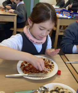 Heritage Year 2 pupils make pizzas during an enrichment session