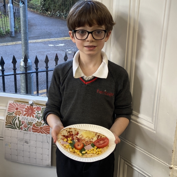 Heritage Year 2 pupils make pizzas during an enrichment session