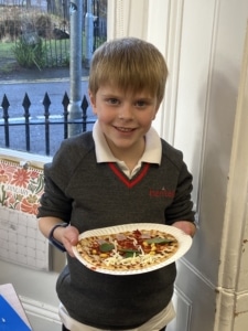 Heritage Year 2 pupils make pizzas during an enrichment session