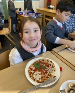 Heritage Year 2 pupils make pizzas during an enrichment session