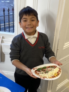 Heritage Year 2 pupils make pizzas during an enrichment session