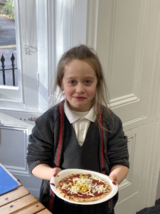 Heritage Year 2 pupils make pizzas during an enrichment session