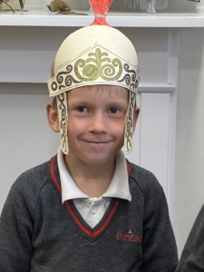 Heritage Year 2 pupils made and tried on their own Roman helmets