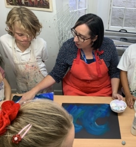 Heritage Year 4 pupils paint water and waves.