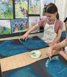 Heritage Year 4 pupils paint water and waves.