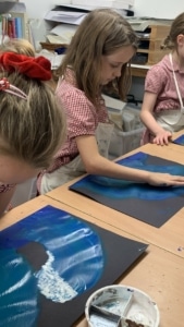 Heritage Year 4 pupils paint water and waves.