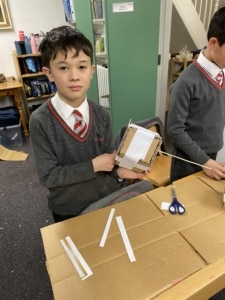 Heritage Year 5 pupils building cardboard windmills during a STEM enrichment activity.
