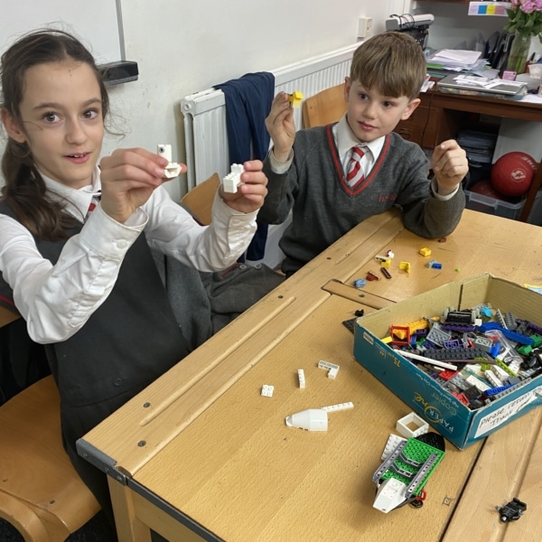Year 6 pupils building Lego creations during an enrichment session.