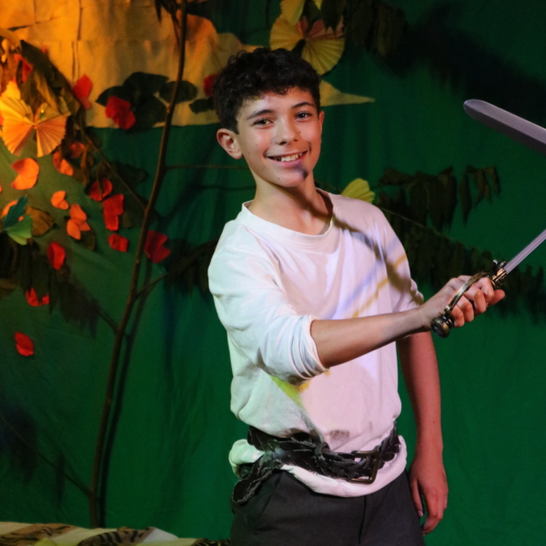 Year 8 pupils performing The Tempest on stage